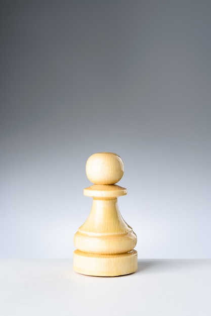 White pawn on white table