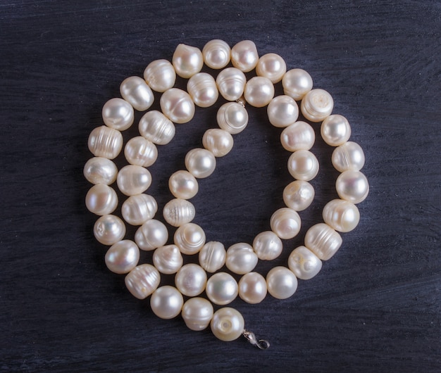 White pearl beads on a black background