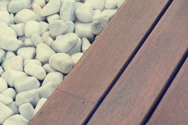 White pebbles and wooden walkway