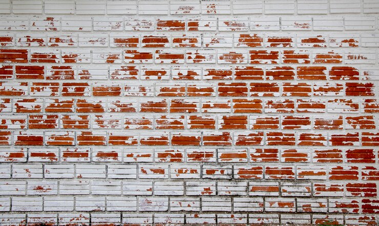 Photo white peeling painted as old red brick wall.