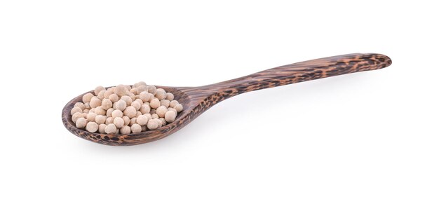 White Pepper seeds in wooden spoon on white background