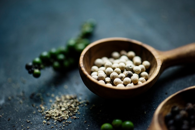 White pepper in wooden spoon