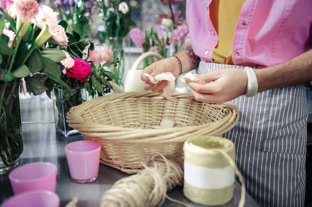 White petals. Close up of male hands that holding petals, creating tender basket