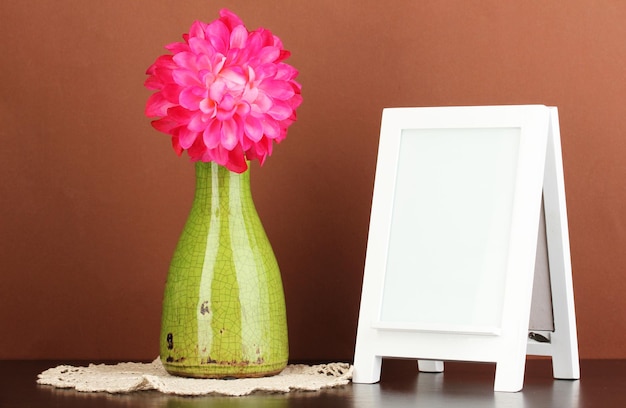 White photo frame for home decoration on brown background