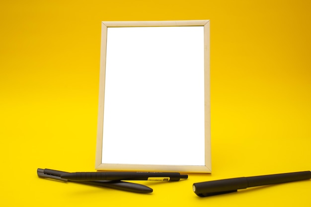 White photo frame on yellow background