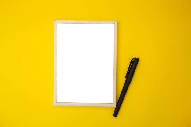 White photo frame on yellow background