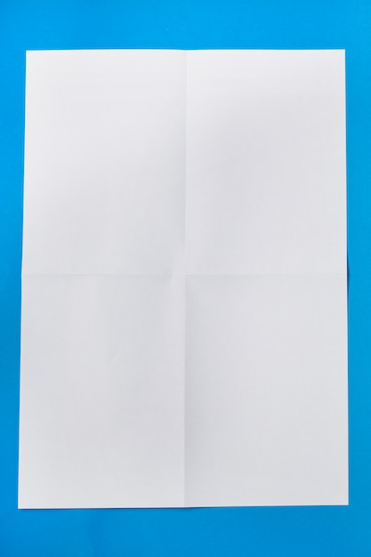 Photo white piece of paper over a blue background.