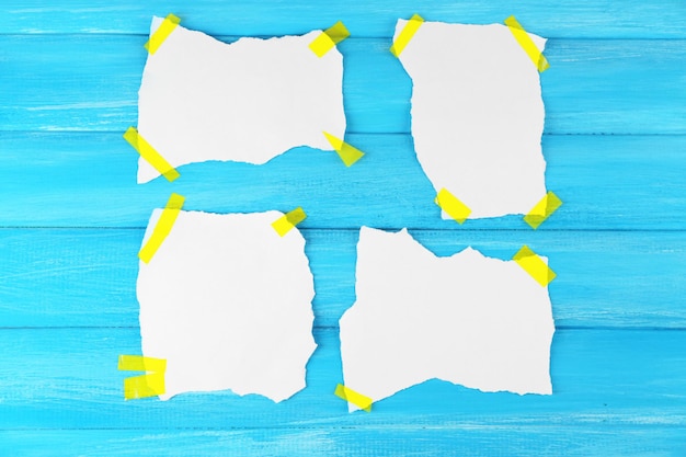 White pieces of paper attached on wooden background