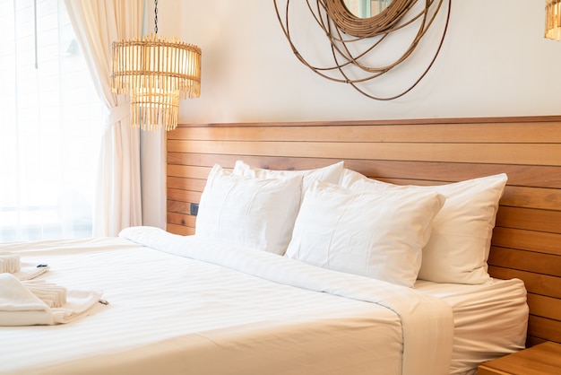 white pillow decoration on bed in bedroom interior