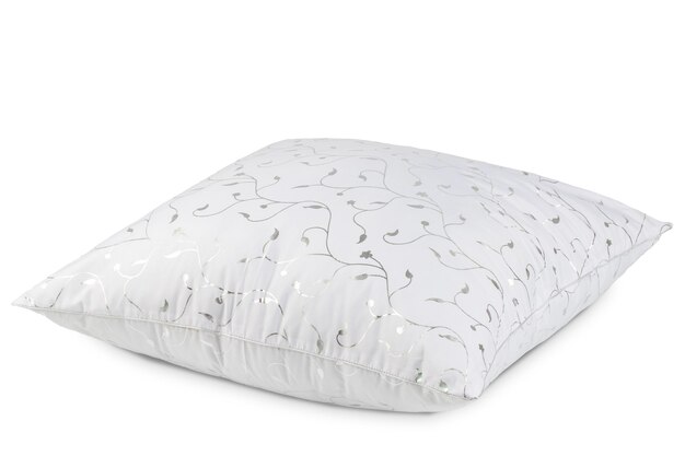 A white pillow with a floral pattern on it.