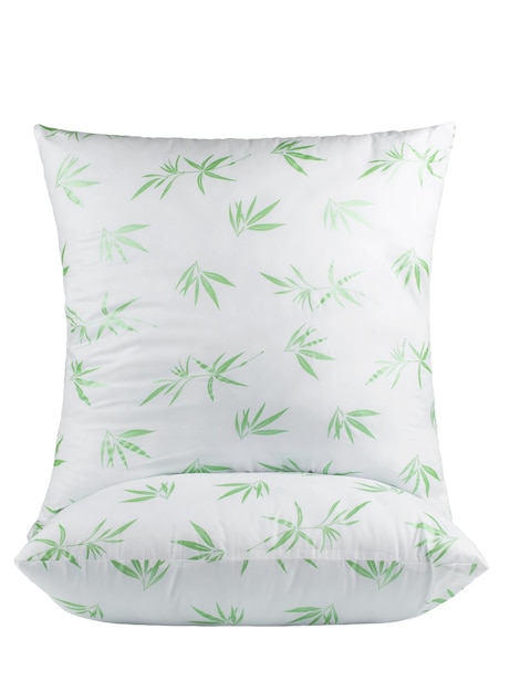 A white pillow with a green bamboo pattern on it.