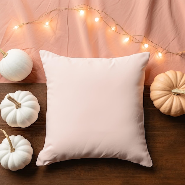 a white pillow with pumpkins and a string of lights behind it
