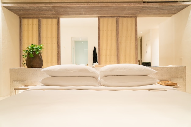 white pillows decoration on bed in luxury hotel resort bedroom