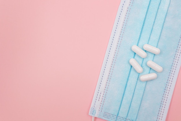White pills or tablets on medical face mask