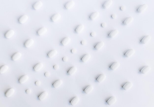 White pills on the white background