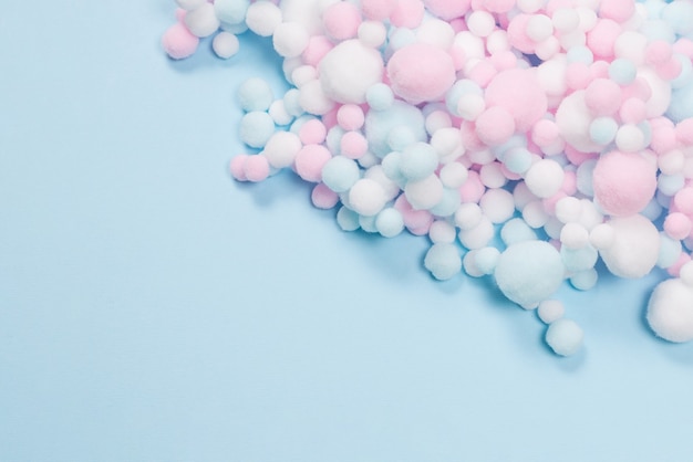 Photo white, pink and blue soft pompons as a background. bright background.