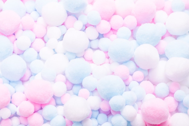 White, pink and blue soft pompons background.