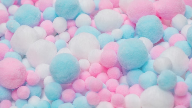 White, pink and blue soft pompons background.