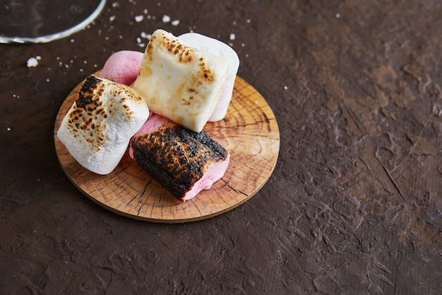 White and pink marshmallows on a wooden stand for Irish cream liqueur