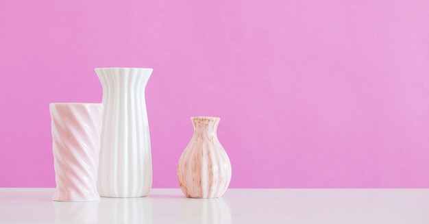 White and pink vases  on pink background