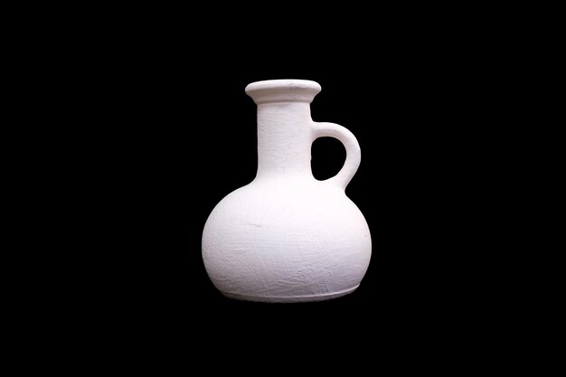 White plaster jug isolated on a black background High quality photo