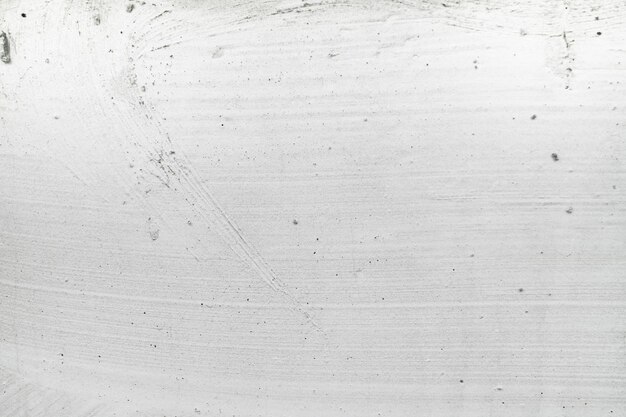 Foto il grigio sporco del cemento di struttura della priorità bassa della parete intonacata bianca con il disegno astratto di colore grigio è leggero con sfondo bianco