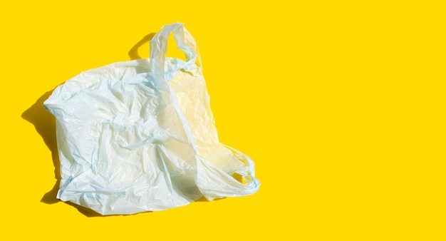 White plastic bag on yellow surface