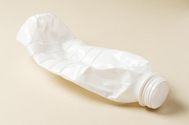 white plastic bottle on beige background the concept of nature pollution copy space