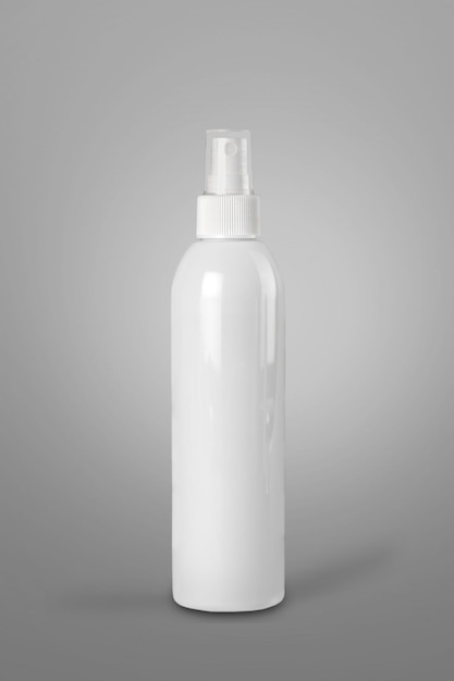 Photo white plastic bottle with atomizer pump a desk