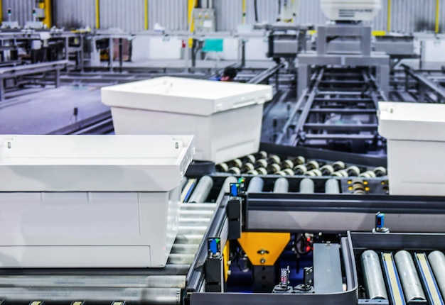 White plastic boxes on conveyor belt. parcels transportation system concept