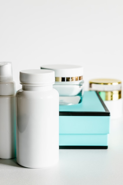 Photo white plastic cosmetic bottles and turquoise and black gift box.