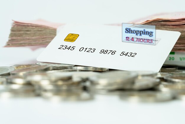 white plastic credit card with coin and banknotes