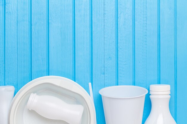 White plastic waste for recycling on blue background