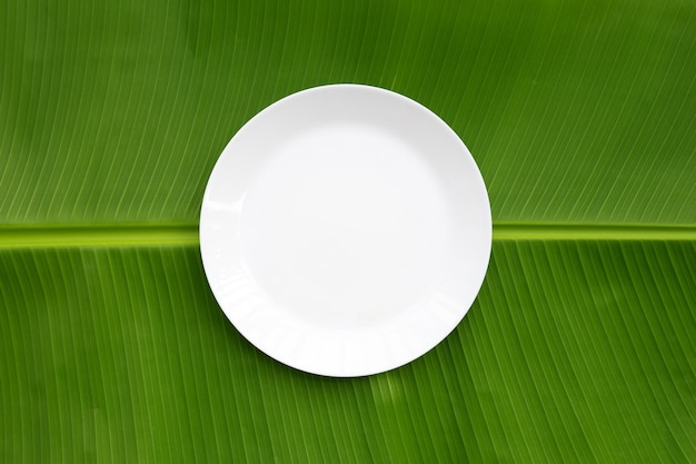 White plate on banana leaf