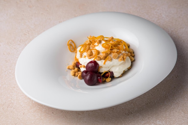 White plate and cake on a grey background White cream honey cake with walnuts