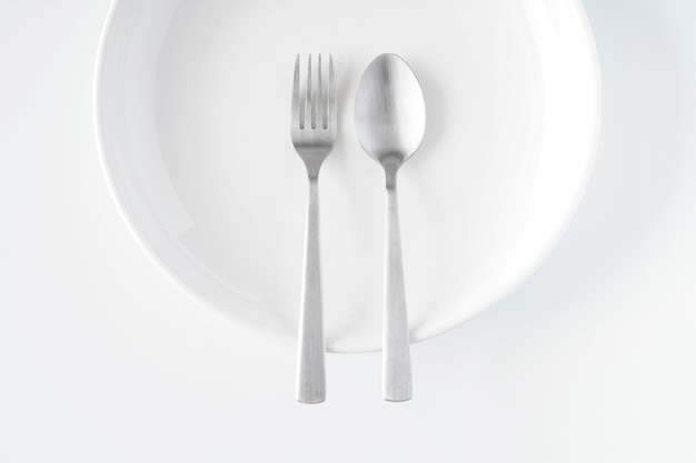 White plate, fork, spoon