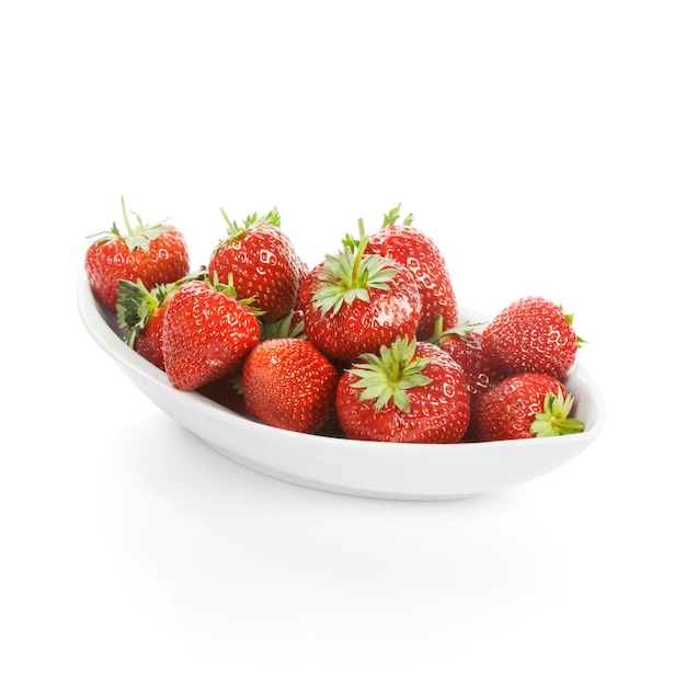 White plate of fresh strawberries on white background