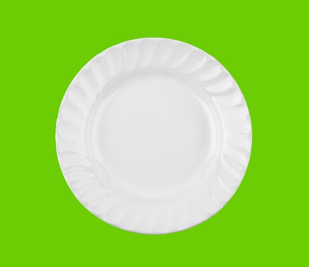 White plate isolated on green background