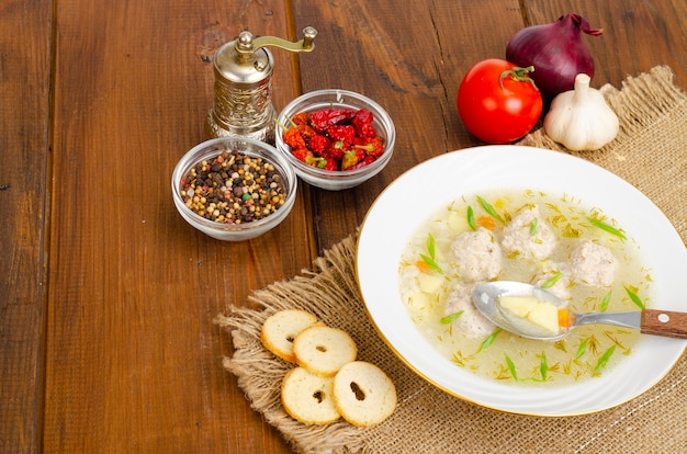 White plate of meatball soup