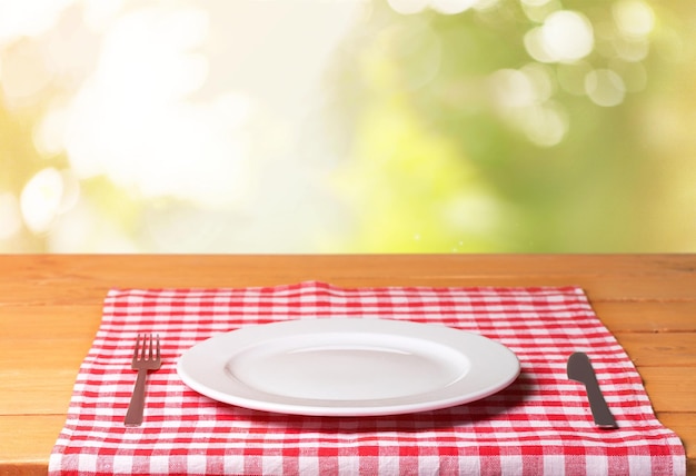 White Plate on napkin on wooden table