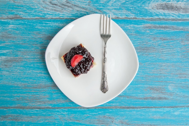 White plate with a piece of cheesecake 