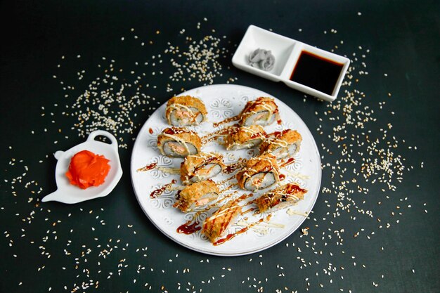 White Plate With Sushi and Small Bowl of Sauce