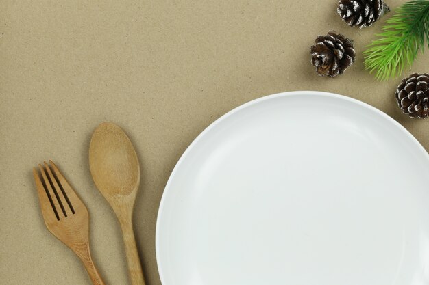 White plate and wooden spoon in Christmas concept.