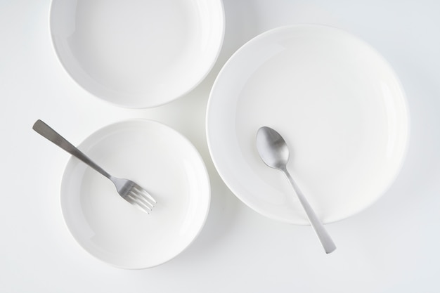 White plates, fork, spoon