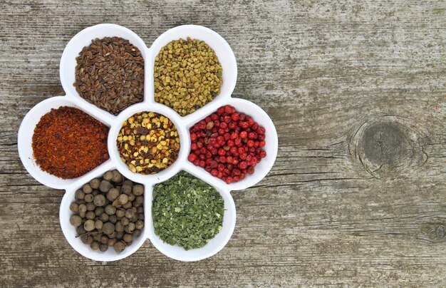 White porcelain bowl with spices on wooden background