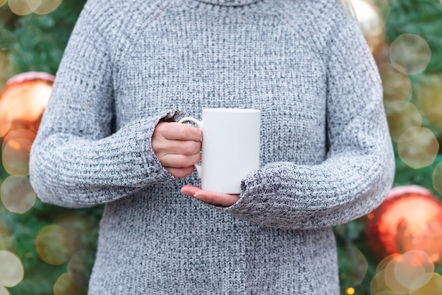 White porcelain coffee mug, cup in woman hands,