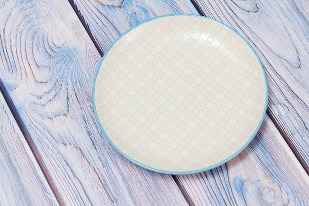 White porcelain plate on the wooden boards