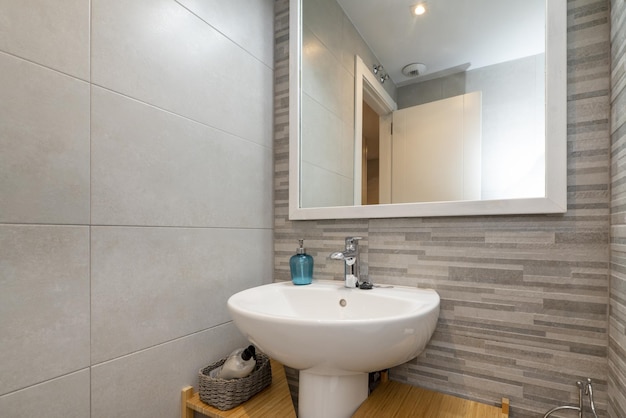 A white porcelain sink in a small bathroom