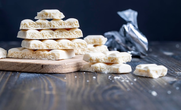 White porous chocolate on a wooden table