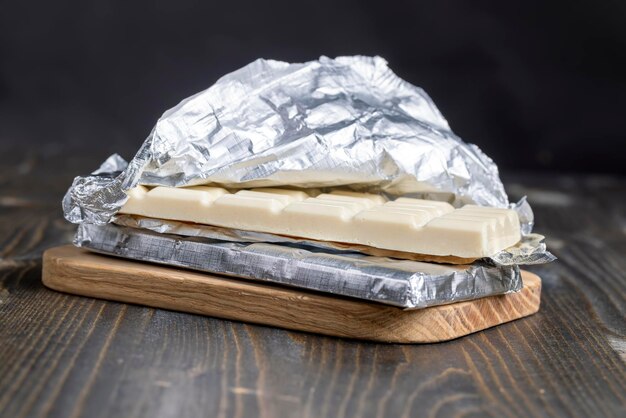 White porous chocolate on a wooden table